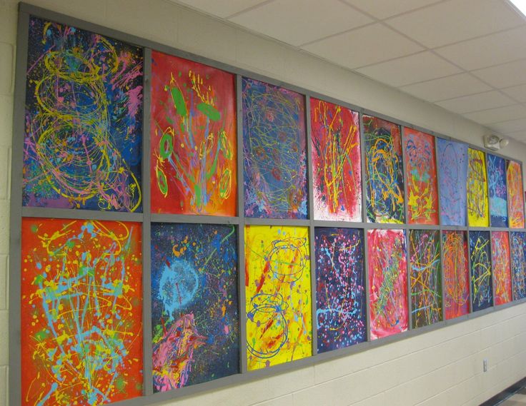 a wall with many different colored paintings on it