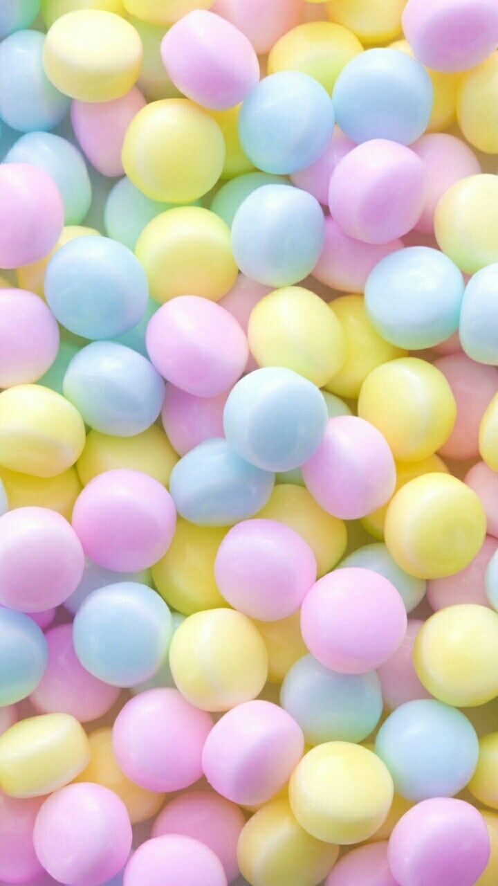 pastel colored candies are scattered on top of each other