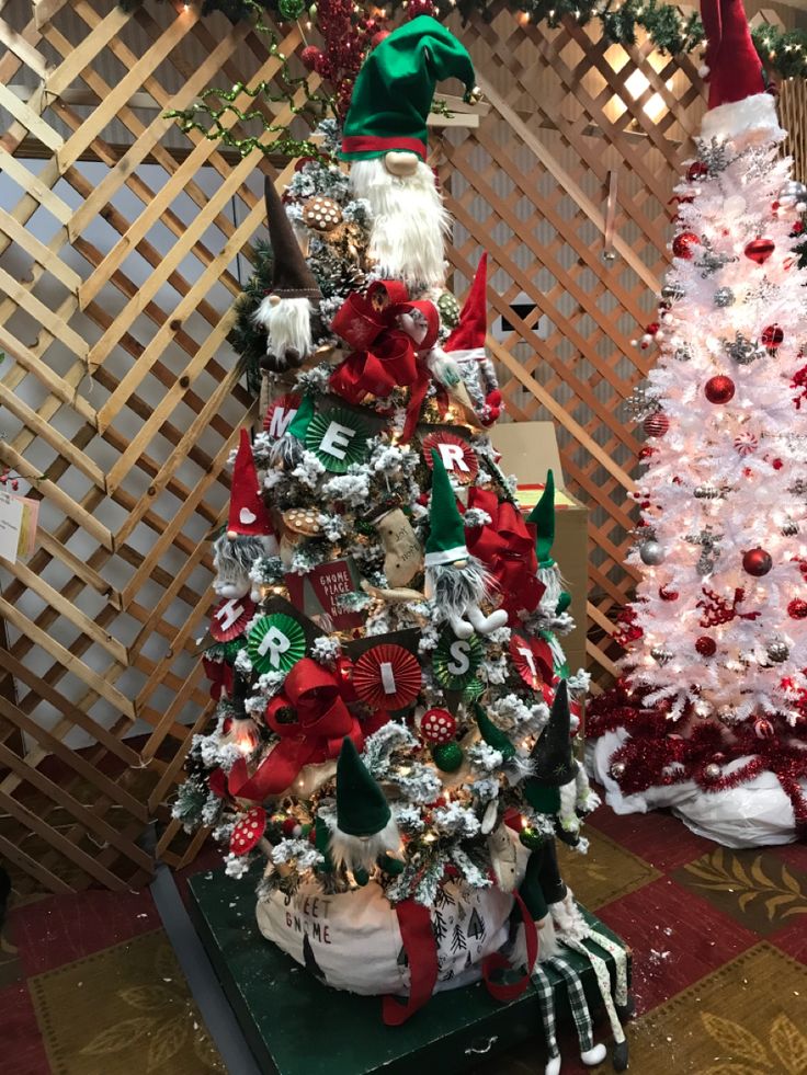 two decorated christmas trees sitting next to each other