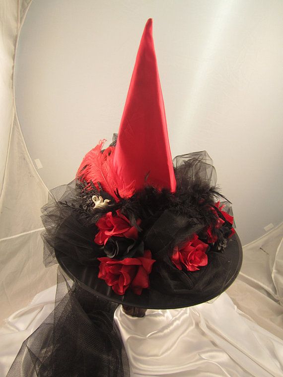 a black hat with red flowers on it