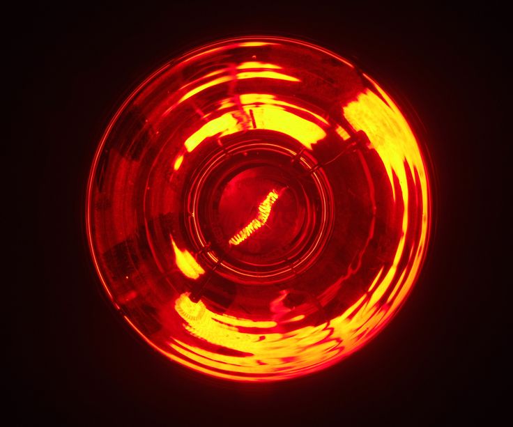 a close up shot of a red light on a black background with only the top part visible