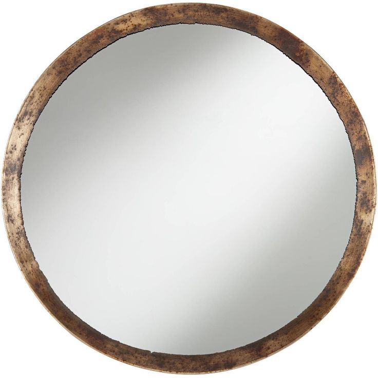 a round wooden mirror hanging on the wall in front of a white background with an old wood frame