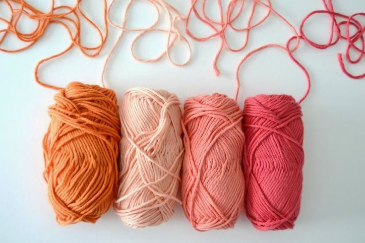 three skeins of yarn are lined up next to each other