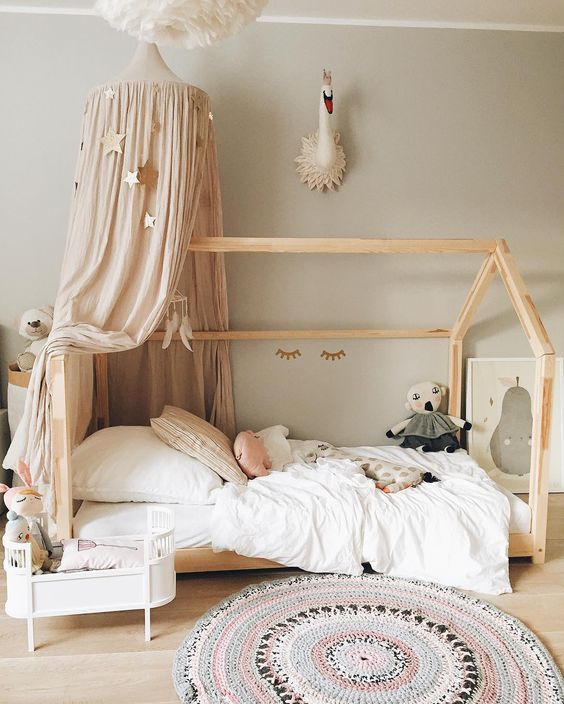 an instagramted photo of a child's room with a bed and canopy