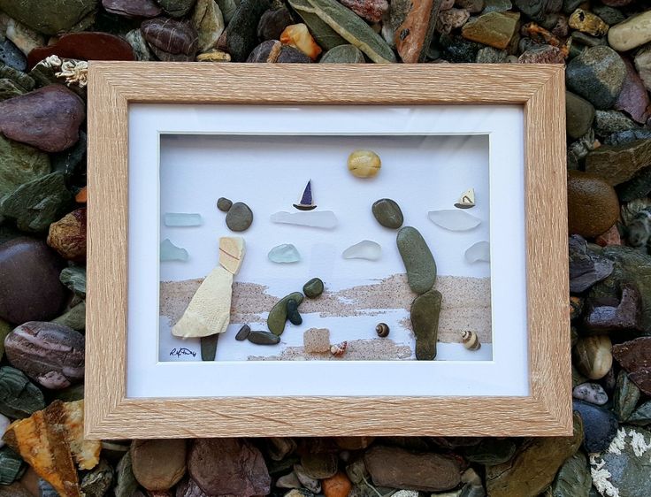 a frame with some rocks and sand in it