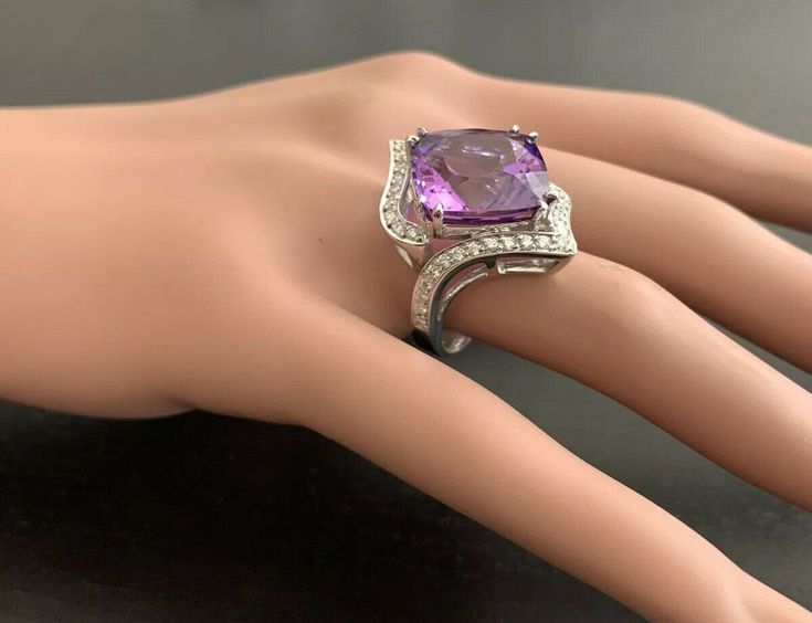 14.70 Carats Natural Amethyst and Diamond 14K Solid White Gold Ring Suggested Replacement Value: Approx. $5,500.00 Total Natural Square Cushion Shaped Amethyst Weights: Approx. 14.00 Carats Amethyst Measures: Approx. 15.00 x 15.00mm Natural Round Diamonds Weight: Approx. 0.70 Carats (color G-H / Clarity SI1-SI2) Ring total weight: Approx. 12.0 grams Disclaimer: all weights, measurements and colors are approximate and may vary slightly from the listed dimensions or as seen in the image. All pictu Elegant Purple Gemstones With Diamond Accents, Luxury Amethyst Gemstones With Accent Stones, Luxury White Gold Amethyst Ring, Cushion Cut Fine Jewelry Gemstones For Formal Occasions, Fine Jewelry Amethyst Ring With Diamond Accents, Cushion Cut Gemstones For Formal Fine Jewelry, Luxury Silver Amethyst Ring, Luxury White Gold Amethyst Ring With Diamond Accents, Luxury Formal Round Cut Gemstones