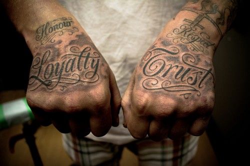 two hands that have tattoos on them with the words beauty and strength written in cursive writing