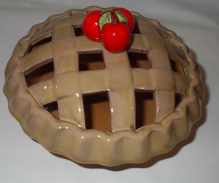 there is a pie that has two tomatoes on top of it and one tomato in the middle