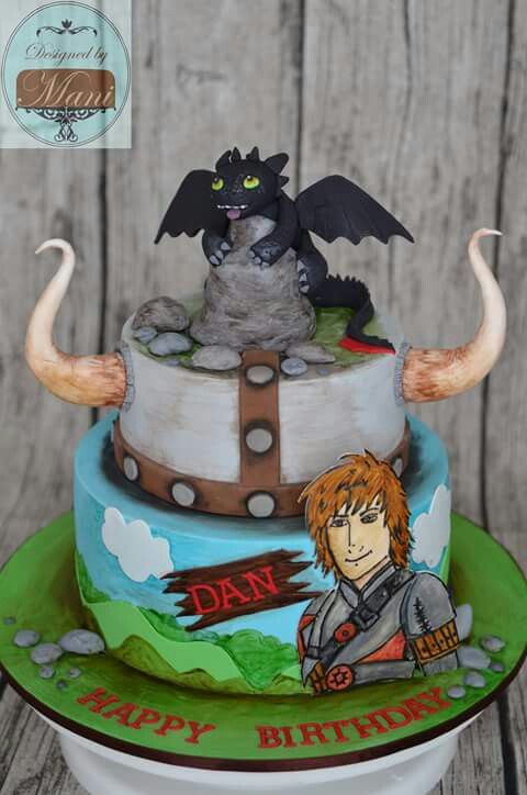 a birthday cake with an image of a cat and dragon on it