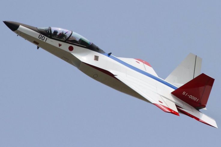 a red, white and blue fighter jet flying in the sky