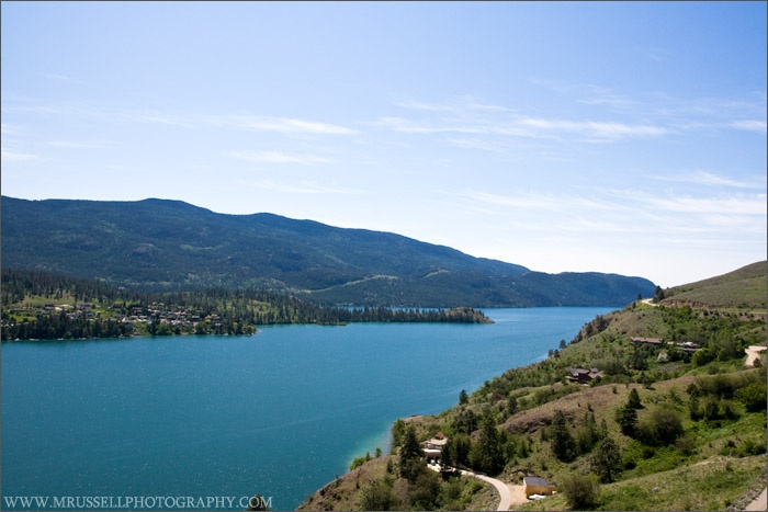 a scenic view of a lake surrounded by mountains