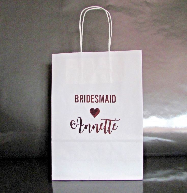 a white bag with the words bridesmaid and an i love heart on it