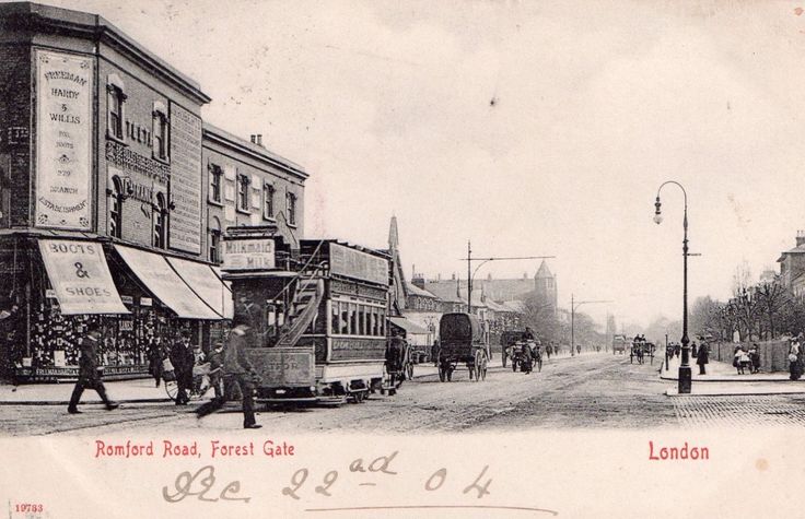 an old black and white photo shows people walking down the street in front of buildings