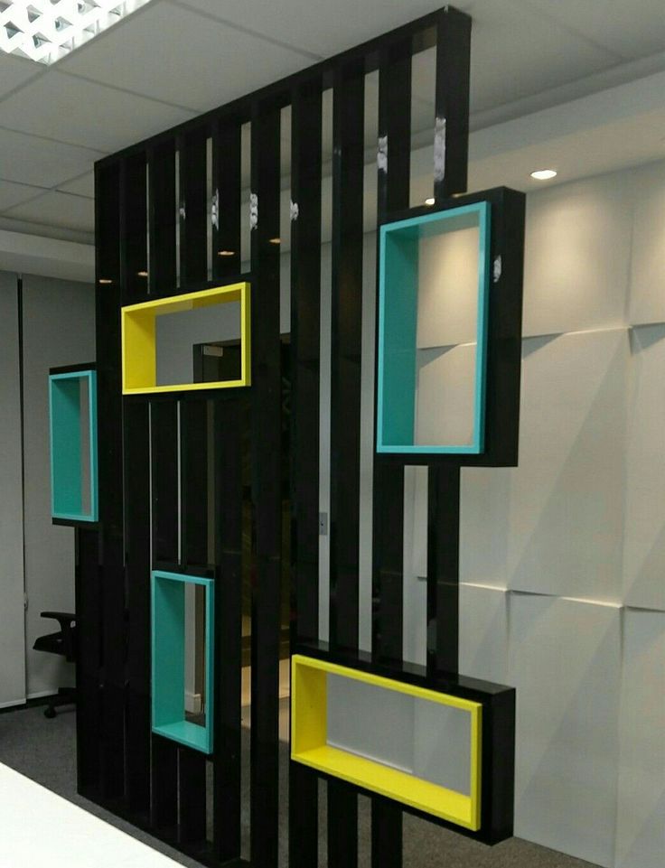 an office cubicle with black, yellow and blue frames