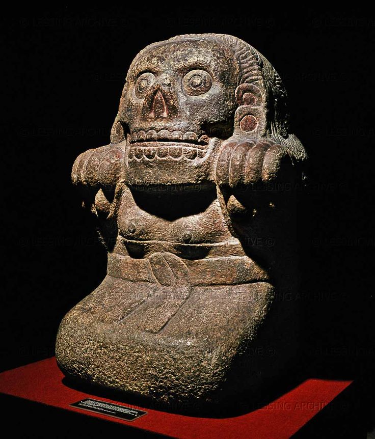 an ancient statue is on display in the dark with its eyes closed and mouth wide open