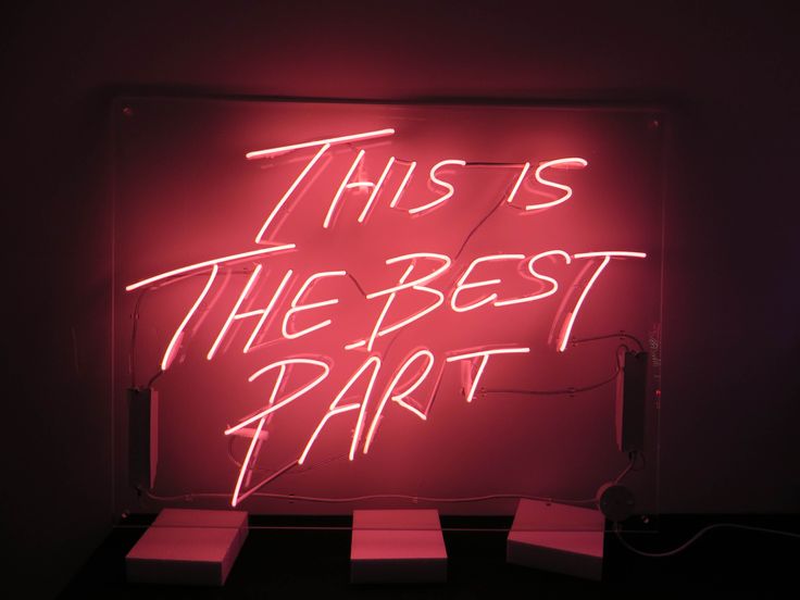 a neon sign that says, this is the best part on display in a dark room