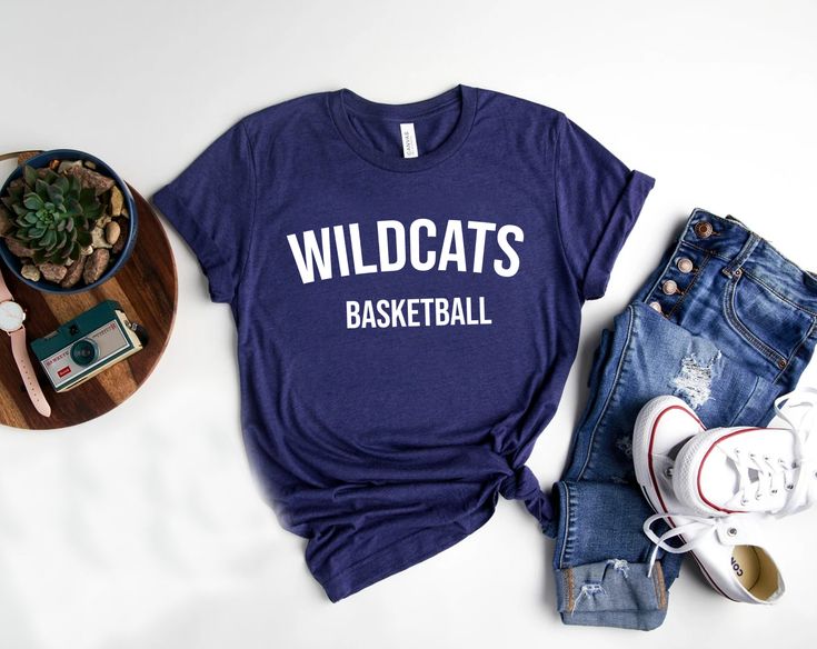 Show your school spirit with our Wildcats shirts, perfect for every sport and club! 🐾 Whether you're cheering from the sidelines, hitting the field, or representing your favorite club, these shirts are made for you! Customize with your sport or club name to make it uniquely yours. Go Wildcats! 🎉 Bella and Canvas Unisex TShirt #WildcatsPride #TeamSpirit #ClubLife #WildcatsNation #GoWildcats #SchoolSpirit #GameDayReady #SupportYourTeam #BootsandRootsApparel #Mompreneur #CustomWildcatsShirts #Pro Team Spirit T-shirt With Team Name For College, Varsity T-shirt For College Football Season, Varsity T-shirt With Team Name For College, Sporty University Logo T-shirt For College, Sporty College T-shirt With Team Logo, Sporty College Tops With University Logo, Varsity T-shirt For Football Season Sports Events, College Football Season T-shirt With Screen Print, College Football Season School Spirit T-shirt