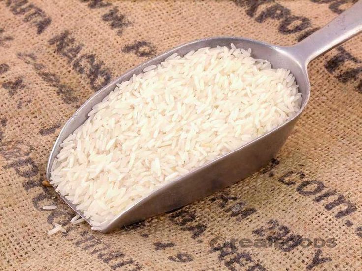 a spoon filled with white powder sitting on top of a burlap covered floor