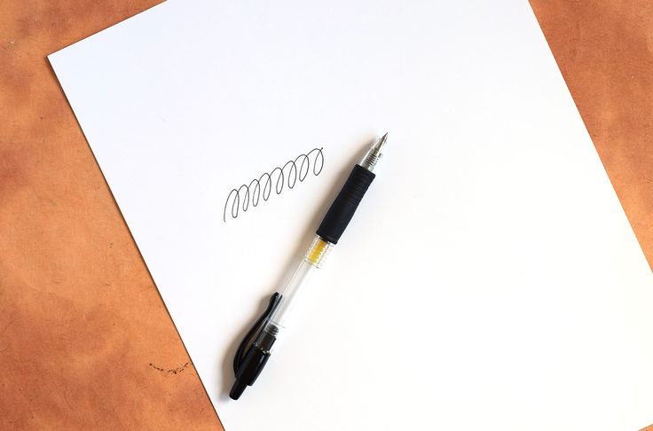 a pen sitting on top of a piece of paper