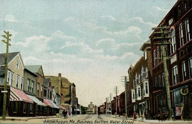 an old photo of a city street with buildings