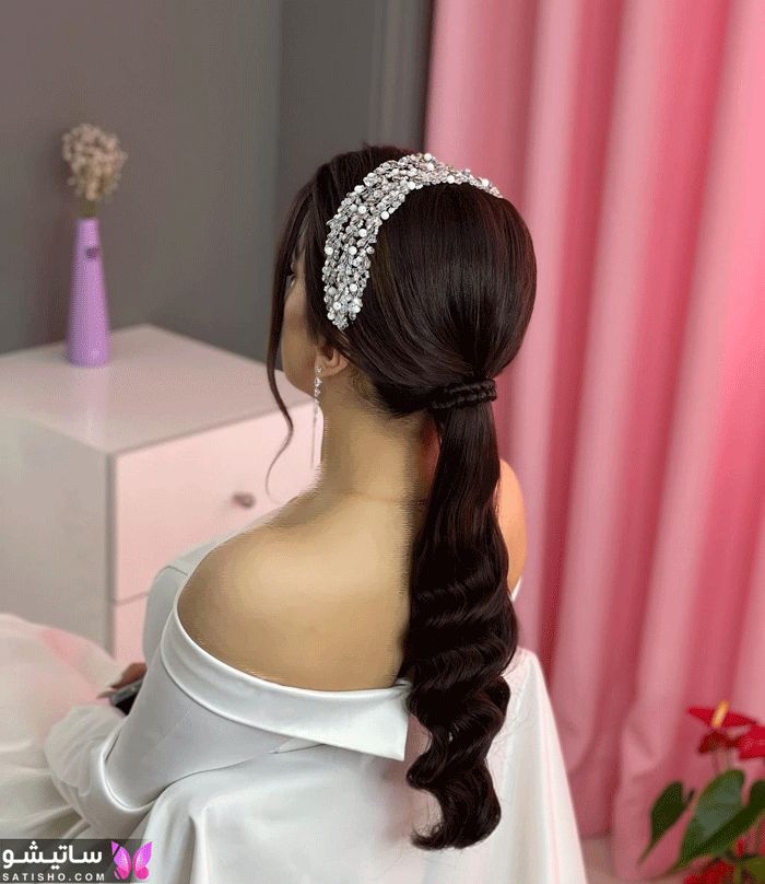 a woman with long hair wearing a white dress and a tiara on her head