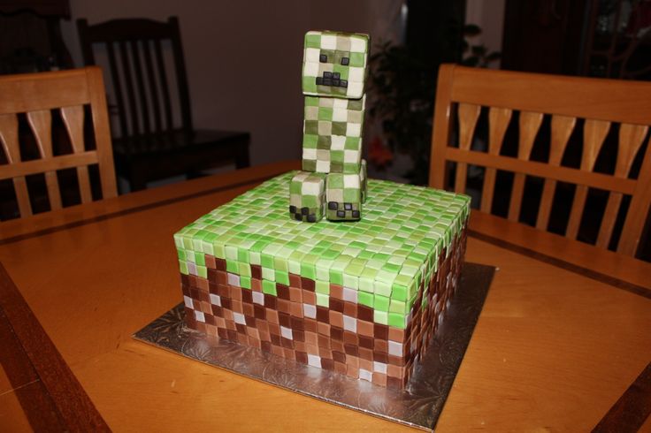 a green cake sitting on top of a wooden table