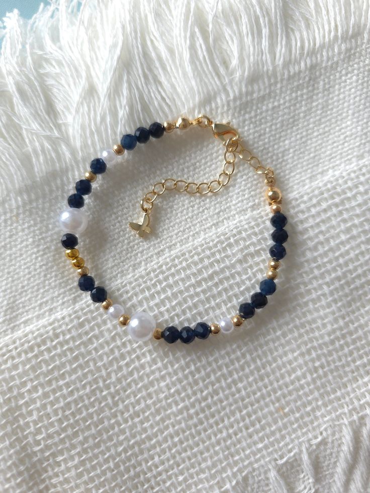 FOR OTHER DAINTY BEADED BRACELETS: https://www.etsy.com/ca/shop/ArtiChouXCanada?ref=seller-platform-mcnav%C2%A7ion_id§ion_id=46088511 Bracelet Length: 13-18cm (5.1-7 inches) with a 14k gold filled extender. But if you require a different size or prefer a personalized touch, please don't hesitate to get in touch. This bracelet features beautiful deep blue colors: blue sapphire gemstones, faux pearls and gold plated seed beads.  Thread may be visible since it is a handmade product   SIZING  Wrap a Blue And Gold Bracelets, Navy Blue Bracelet, Blue Bracelet Beads, Beaded Bracelets Blue, Gold Beads Bracelet, Blue Bead Bracelet, Simple Beaded Bracelets, Pearls Bracelet, Blue Beaded Bracelets