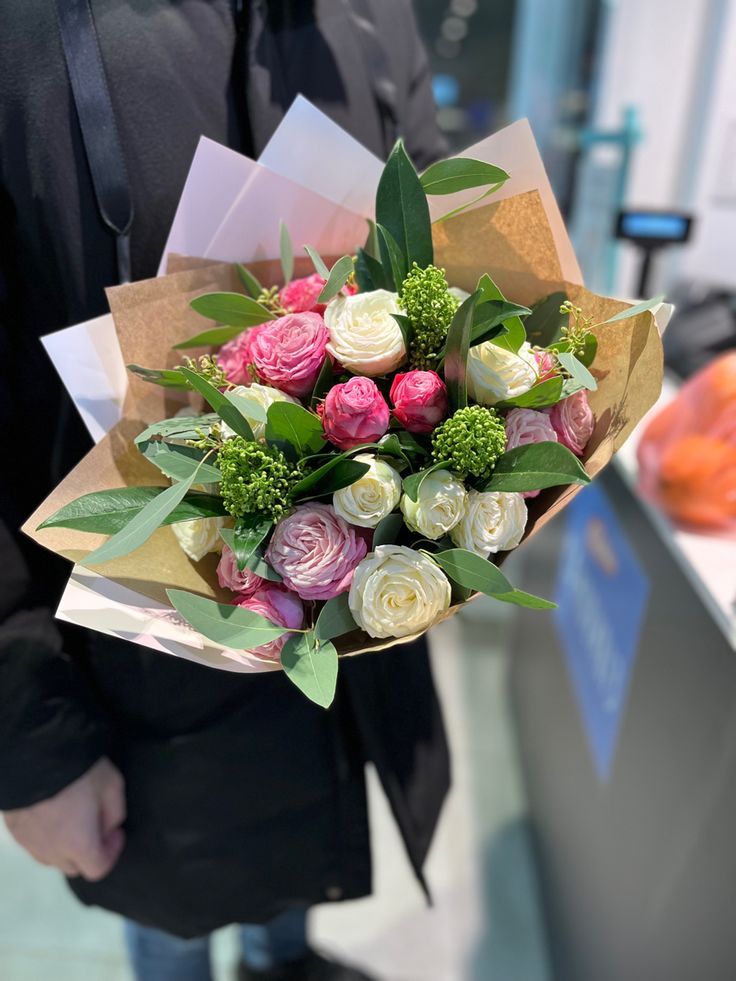 a person holding a bouquet of flowers in their hands