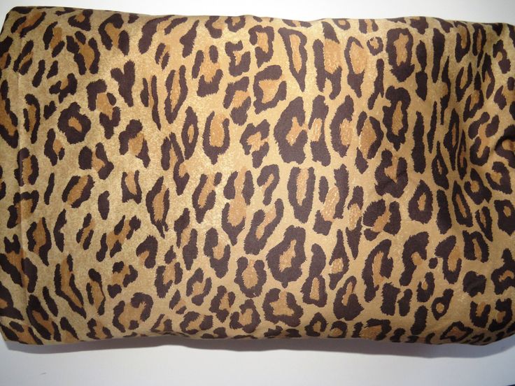 a leopard print pillow on a white surface