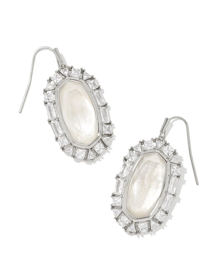 Our iconic statement earrings get a luxurious crystal frame in the Elle Silver Crystal Frame Drop Earrings in Ivory Mother-of-Pearl. Featuring baguette, trillion, and princess cut crystals, these earrings give off an oh-so-glamorous sparkle with every turn of your head. Metal Rhodium Over Brass Material Ivory Mother-of-Pearl Closure Earwire Size 1.04"L X 0.64"WDue to the one-of-a-kind nature of the medium, exact colors and patterns may vary slightly from the image shown. | Kendra Scott Elle Silv Crystal Frame, Car Fragrance, Statement Drop Earrings, French Wire, Silver Crystal, Silver Drop Earrings, Gold Drop Earrings, Brass Material, Accessories Jewelry