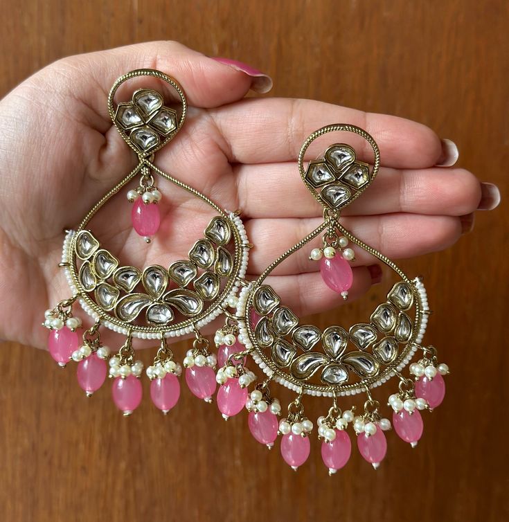 Beautiful and high quality Pink Kundan Earrings with gold detailing. These earrings add a Royal touch to any outfit. If you are looking for a pair of earrings that really make a statement, these are the ones for you!  In case of any queries, please feel free to contact us and we will be happy to assist you.  Happy shopping! Gold Dual-tone Kundan Earrings, Dual-tone Chandbali Earrings For Festive Occasions, Festive Dual-tone Chandbali Earrings, Navratri Chandbali Earrings For Pierced Ears, Dual-tone Earrings For Diwali Celebration, Festive Chandbalis For Navratri With Pierced Ears, Festive Navratri Chandbalis With Pierced Ears, Traditional Dual-tone Kundan Earrings, Chandbali Earrings For Navratri With Pierced Ears