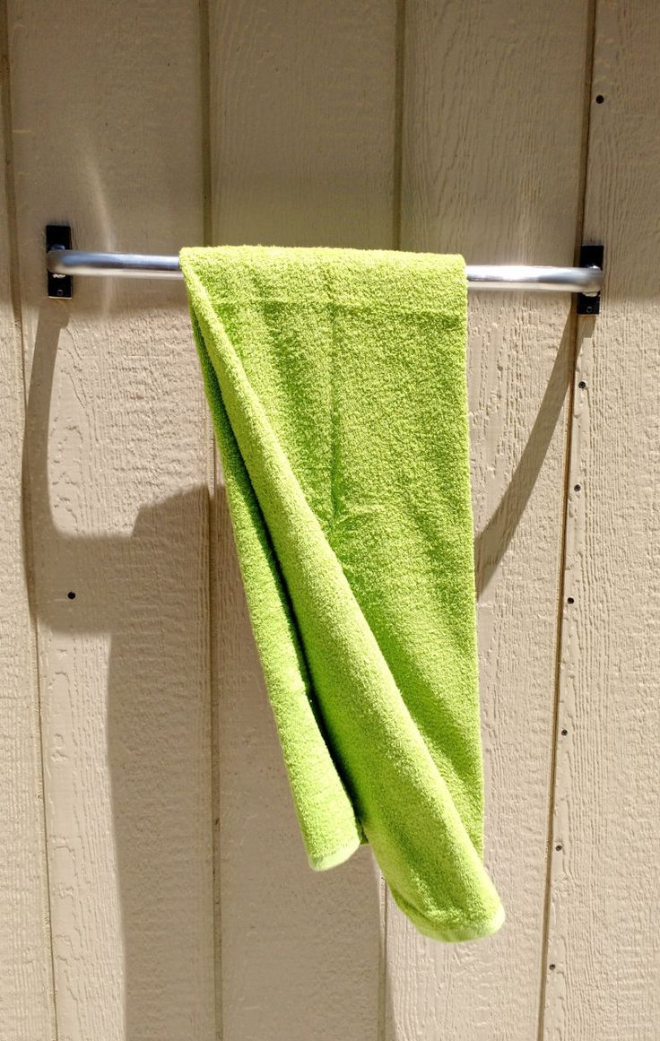 a green towel hanging on a clothes line