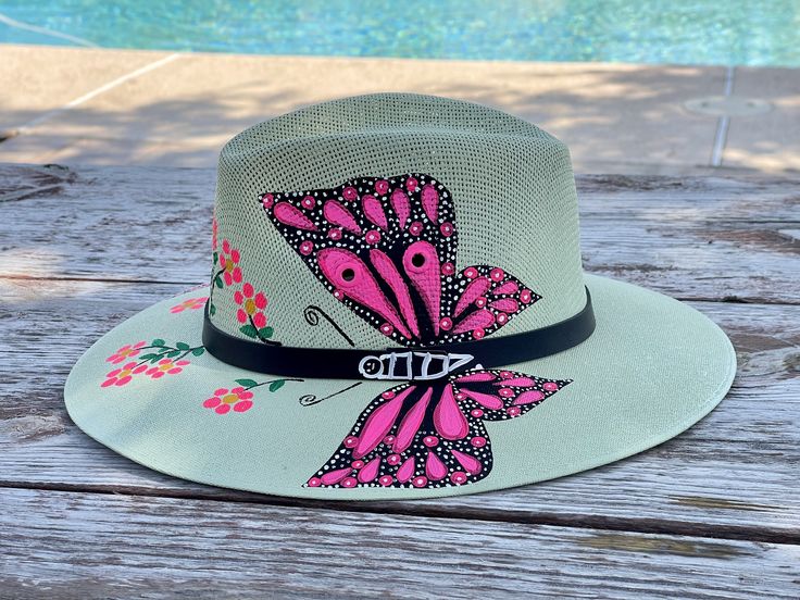 Beautiful bold hand-painted sun hat.  This is a perfect gift for any occasion or to add to your collection.  * Imported and Hand Crafted from Cuernavaca, Morelos Mexico * Beautiful Bold Colors * Color of the hat is light olive with bright pink butterflies * Brand New * Size Medium  * Protects face from the sun Whimsical Brimmed Sun Hat For Summer, Pink Vacation Hats With Curved Brim, Pink Vacation Hat With Curved Brim, Pink Curved Brim Vacation Hat, Pink Curved Brim Hat For Vacation, Adjustable Pink Sun Hat For Vacation, Pink Handmade Sun Hat For Festival, Whimsical Adjustable Sun Hat For Summer, Whimsical Adjustable Straw Hat For Summer