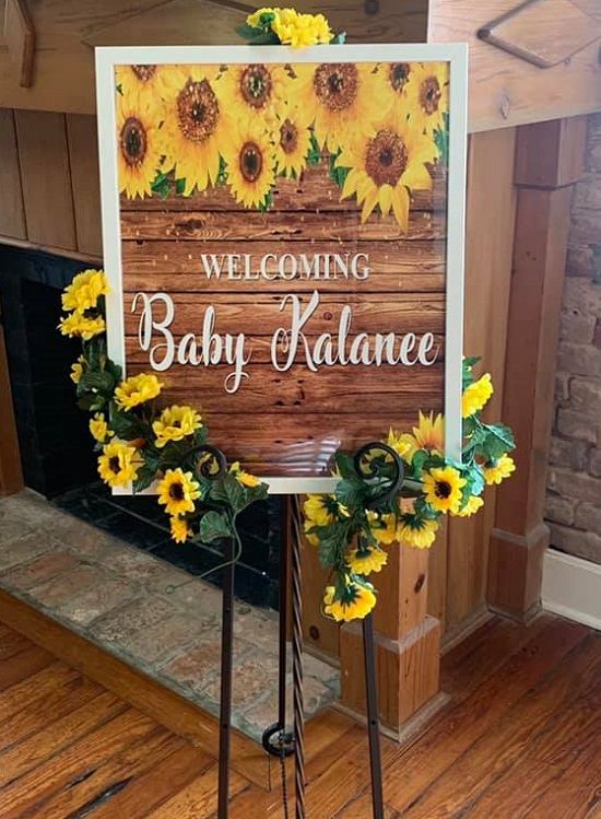 a welcome sign with sunflowers on it