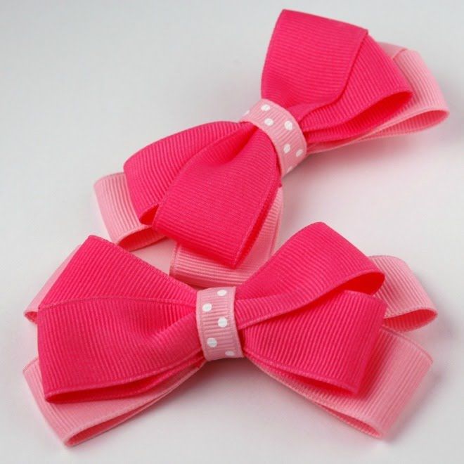 two pink bows with white polka dots on them