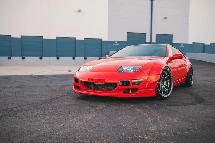 a red sports car parked in a parking lot