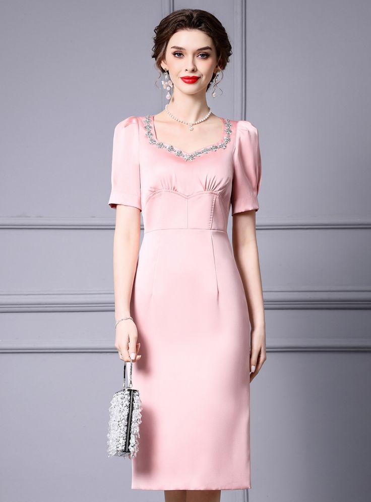 Flaunting a timeless elegance, this pastel pink dress is designed to capture attention with its subtle charm and sophistication. The dress features a beautifully tailored silhouette that gently hugs the body, providing a flattering fit for any figure. The bodice is adorned with delicate embroidery around the neckline, adding a touch of feminine grace and elegance. The puffed short sleeves offer a classic yet modern look, making the dress versatile for various occasions. The skirt falls gracefull Elegant Embellished Midi Dress For Wedding Guest, Pink Square Neck Dress For Banquet, Fitted Pink Embellished Midi Dress, Square Neck Embellished Dresses For Formal Events, Pink Embellished Fitted Midi Dress, Pink Knee-length Formal Evening Dress, Fitted Feminine Evening Dress With Sweetheart Neckline, Elegant Pink Midi-length Evening Dress, Feminine Knee-length Evening Dress