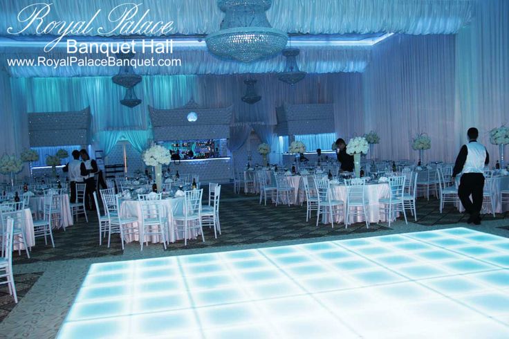 a dance floor with white tables and chairs