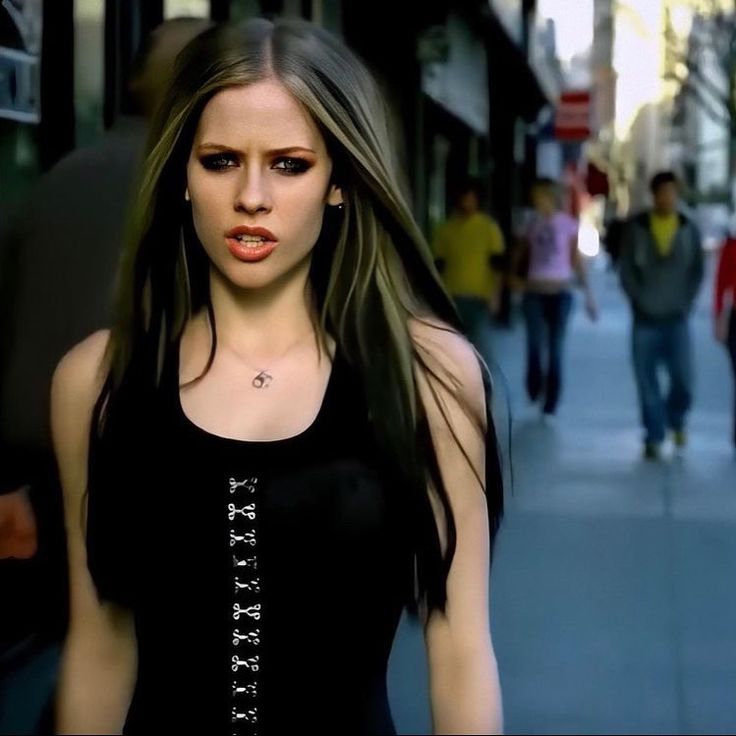 a woman with long hair walking down the street