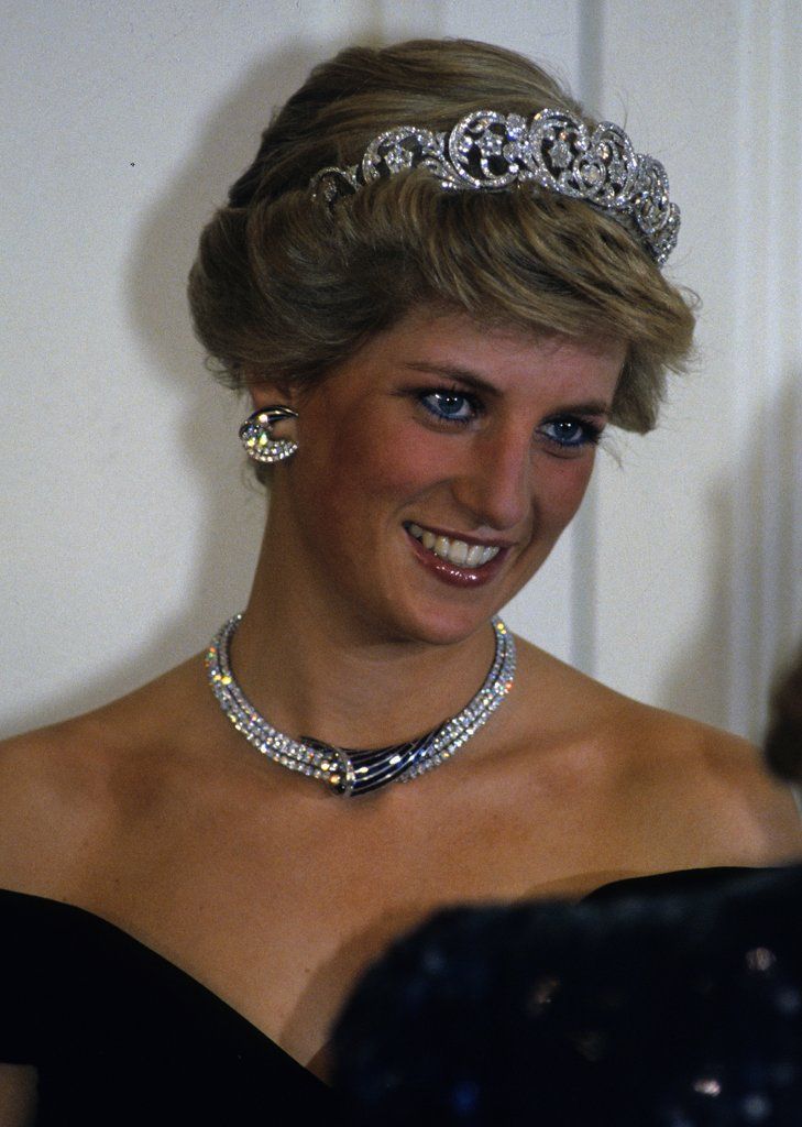 a woman wearing a tiara and smiling for the camera