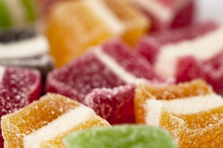 several different colored desserts on a white plate