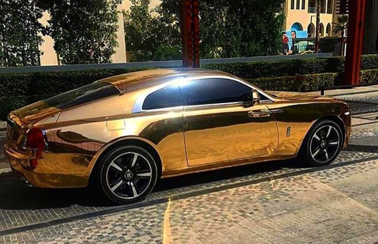 a gold car parked on the side of a road