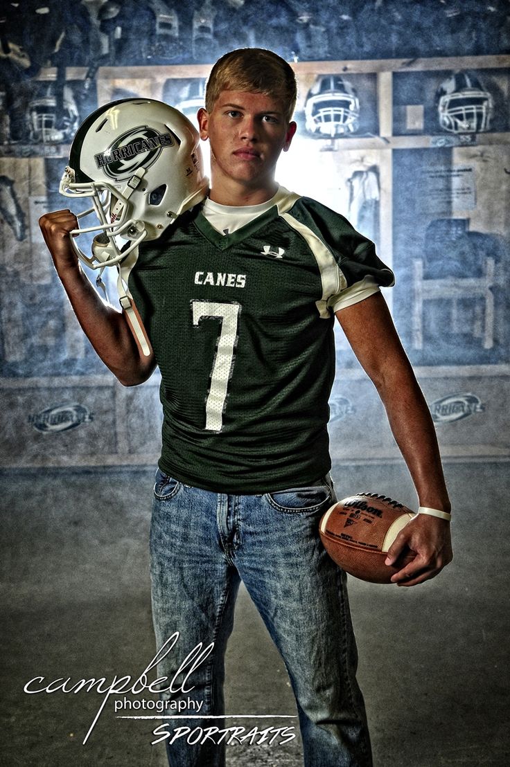 a young man holding a football and helmet