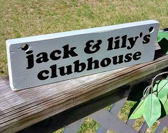 a sign that says jack and lily's clubhouse on the side of a wooden bench