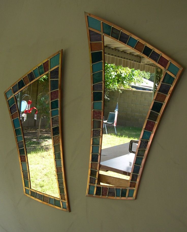 two mirrors that are on the side of a wall