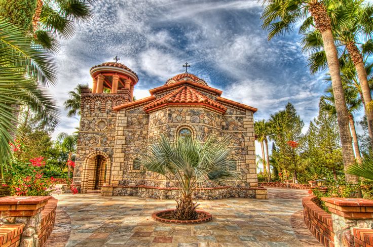 a church surrounded by palm trees on a sunny day