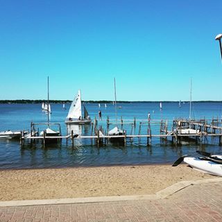 sailboats are docked at the dock on a sunny day in front of the water