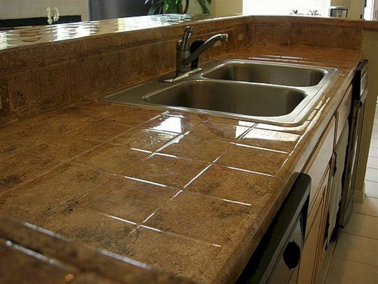 a kitchen counter top with a sink and oven