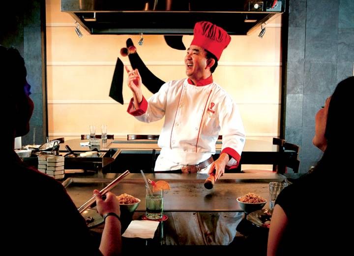 a man in a chef's hat is cooking food