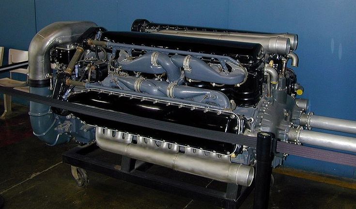 a large engine sitting on top of a metal rack in a room with blue walls